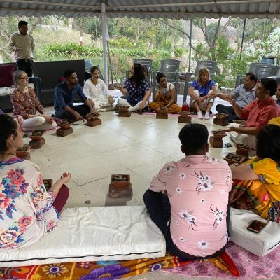 Individuals participating in meditation during a transformative wellness and healing retreat