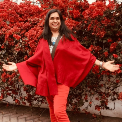 Bhavna, The Golden Light, wearing a red outfit